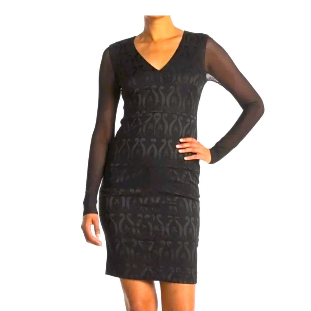 Little black dress. Long shear sleeves. Knee length. Stretchy. Low neck line.